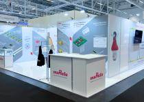 Murata stand at ECOC, 3 walls with a large meeting room and several counters