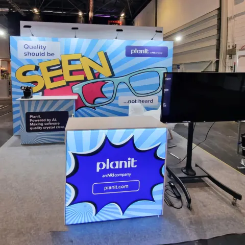 Planit exhibition stand, with a back wall, front and rear counters and a free-standing TV